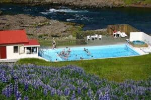 Photo of swimming pool set into the icelandic landscape. 