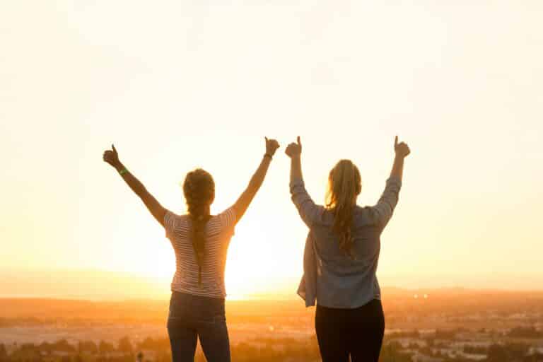 konudager - womans day in Iceland is a day celebrating women. So this image is two women cheering with their arms up, facing into the sun.